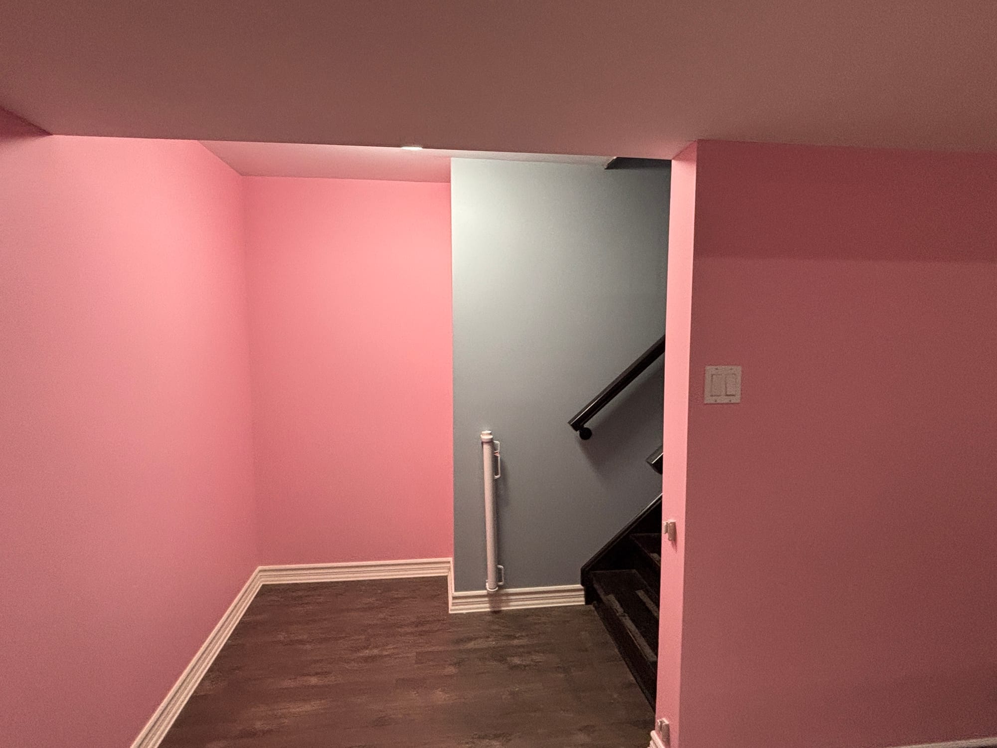 freshly painted pink walls and a light blue one by the stairs