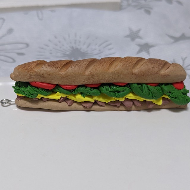 a tiny, footlong-style sub sandwich with toasted-looking bread